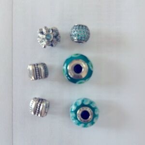 Six Turquoise and Silver Pandora charms. Like new and most are retired